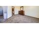 Bright bedroom with plush carpet and neutral walls, leading to an adjacent room at 6464 S Swadley Way, Littleton, CO 80127