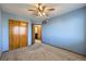 Comfortable bedroom featuring plush carpet, neutral walls, and ample closet space at 6464 S Swadley Way, Littleton, CO 80127