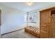 Comfortable bedroom featuring plush carpet, natural light, and a built-in wooden bed at 6464 S Swadley Way, Littleton, CO 80127