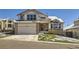 Charming two-story home featuring a two-car garage, brick accents, and a front lawn, with a large front window at 6464 S Swadley Way, Littleton, CO 80127