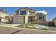 Charming two-story home featuring a two-car garage, brick accents, and a front lawn, with a large front window at 6464 S Swadley Way, Littleton, CO 80127
