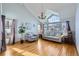 Bright living room with a vaulted ceiling, large windows, hardwood floors, and contemporary furnishings at 6464 S Swadley Way, Littleton, CO 80127