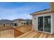 Beautiful back deck with sliding glass door and wood railing overlooking backyard at 24788 E 40Th Ave, Aurora, CO 80019