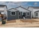 Exterior view showcasing the home's backyard with gray siding, windows, and a small patio area at 24788 E 40Th Ave, Aurora, CO 80019