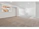 Large finished basement with recessed lighting and neutral carpet; bright window in egress well at 24788 E 40Th Ave, Aurora, CO 80019