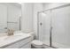Clean bathroom featuring a glass shower enclosure, a white vanity and a decorative mirror at 24788 E 40Th Ave, Aurora, CO 80019