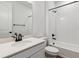 Bathroom featuring sleek fixtures, white cabinets, a shower over tub and a large vanity at 24788 E 40Th Ave, Aurora, CO 80019