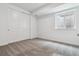 A bright bedroom with neutral walls and carpet with a window and double sliding door closet at 24788 E 40Th Ave, Aurora, CO 80019