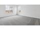 A bright bedroom with neutral walls and carpet with a large window offering views of the neighborhood at 24788 E 40Th Ave, Aurora, CO 80019
