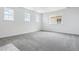 Bright bedroom with multiple windows providing natural light and neutral-toned carpeting at 24788 E 40Th Ave, Aurora, CO 80019