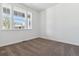 Well-lit bedroom with neutral carpeting and a large window showcasing the neighborhood at 24788 E 40Th Ave, Aurora, CO 80019