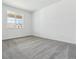 Bright, carpeted bedroom with a large window offering plenty of natural light at 24788 E 40Th Ave, Aurora, CO 80019