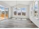 Dining room with large windows, sliding glass door access to deck, and modern chandelier at 24788 E 40Th Ave, Aurora, CO 80019