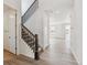 Bright entryway with a staircase, wood railing and a view into the spacious living area at 24788 E 40Th Ave, Aurora, CO 80019