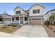 Charming two-story home featuring a covered porch, two-car garage and a combination of stone and siding exterior at 24788 E 40Th Ave, Aurora, CO 80019