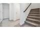 Carpeted stairs with a wooden handrail lead to the upper level at 24788 E 40Th Ave, Aurora, CO 80019