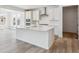Bright kitchen with white cabinets, stainless steel appliances, a spacious center island, and ample natural light at 24788 E 40Th Ave, Aurora, CO 80019