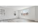 Bright living room with multiple windows offering lots of natural light and light wood-look flooring at 24788 E 40Th Ave, Aurora, CO 80019