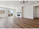 Expansive living room featuring hardwood floors, a fireplace, and sliding glass doors to the patio at 24788 E 40Th Ave, Aurora, CO 80019