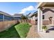 Spacious backyard features green grass and wood fencing, offering privacy and a tranquil outdoor setting at 2161 Willow Ct, Denver, CO 80238