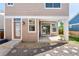 Covered porch and backyard with stone landscaping and a sliding door leading to the home's interior at 2161 Willow Ct, Denver, CO 80238
