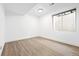 This basement features a spacious living area with laminate floors, neutral paint, recessed lighting, and a window at 2161 Willow Ct, Denver, CO 80238