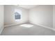 Bright empty bedroom featuring carpet and a large window with backyard view at 2161 Willow Ct, Denver, CO 80238
