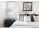 Cozy bedroom showcasing a stylish nightstand and modern abstract artwork at 2161 Willow Ct, Denver, CO 80238
