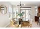 Bright dining area with a round table, modern chandelier, and access to the backyard at 2161 Willow Ct, Denver, CO 80238