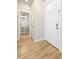 Bright entryway featuring beautiful hardwood floors and a view of the half bath at 2161 Willow Ct, Denver, CO 80238
