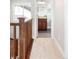 Hallway with wood railing, carpet, and a view of the bathroom at 2161 Willow Ct, Denver, CO 80238