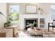 Bright living room features a fireplace, built-in shelving, and a cozy seating area at 2161 Willow Ct, Denver, CO 80238