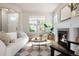 Comfortable living room with a fireplace, large windows, and stylish furnishings at 2161 Willow Ct, Denver, CO 80238