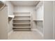 Walk-in closet featuring built-in shelving and ample storage space at 2161 Willow Ct, Denver, CO 80238