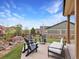 Backyard with four gray chairs and a white couch on a patio, as well as beautiful landscaping at 2463 Tavern Way, Castle Rock, CO 80104