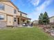 Backyard with a patio and outdoor furniture, surrounded by a beautiful lawn and landscaped areas at 2463 Tavern Way, Castle Rock, CO 80104