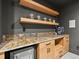 Entertainers bar area features a granite countertop, mini fridge and floating shelving at 2463 Tavern Way, Castle Rock, CO 80104