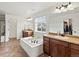 Bright bathroom with double vanities, a soaking tub, and elegant finishes, creating a spa-like experience at home at 2463 Tavern Way, Castle Rock, CO 80104