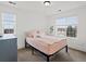 Bedroom featuring a window with natural light, pink bedspread, and neutral walls at 2463 Tavern Way, Castle Rock, CO 80104