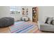 Bright bedroom with a colorful rug, seating and storage at 2463 Tavern Way, Castle Rock, CO 80104
