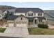 Charming two-story home with a three-car garage, stone accents, and a cozy front porch at 2463 Tavern Way, Castle Rock, CO 80104