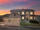 Beautiful home featuring stone details, three-car garage, front porch and attractive sunset at 2463 Tavern Way, Castle Rock, CO 80104