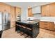 Modern kitchen island with black marble countertops and stainless steel appliances at 2463 Tavern Way, Castle Rock, CO 80104