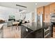 Modern kitchen with a large island, stainless steel appliances, and an open layout connecting to the living area at 2463 Tavern Way, Castle Rock, CO 80104