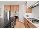 Contemporary kitchen featuring stainless steel appliances, sleek cabinetry, and an island with a contrasting countertop at 2463 Tavern Way, Castle Rock, CO 80104