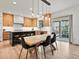 Modern kitchen and dining area with sleek cabinets, black countertops, and natural light at 2463 Tavern Way, Castle Rock, CO 80104
