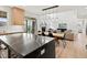 Kitchen with an island, wood floors, and views of the living area, fireplace, and backyard through sliding glass doors at 2463 Tavern Way, Castle Rock, CO 80104