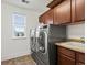 Well-organized laundry room with modern appliances, sink, and cabinets for efficient laundry management at 2463 Tavern Way, Castle Rock, CO 80104