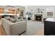 Bright living room with fireplace, stylish decor, and an open floor plan that flows into the kitchen and dining area at 2463 Tavern Way, Castle Rock, CO 80104