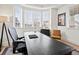 Bright home office featuring a large desk, comfortable seating, and natural light from the bay window at 2463 Tavern Way, Castle Rock, CO 80104